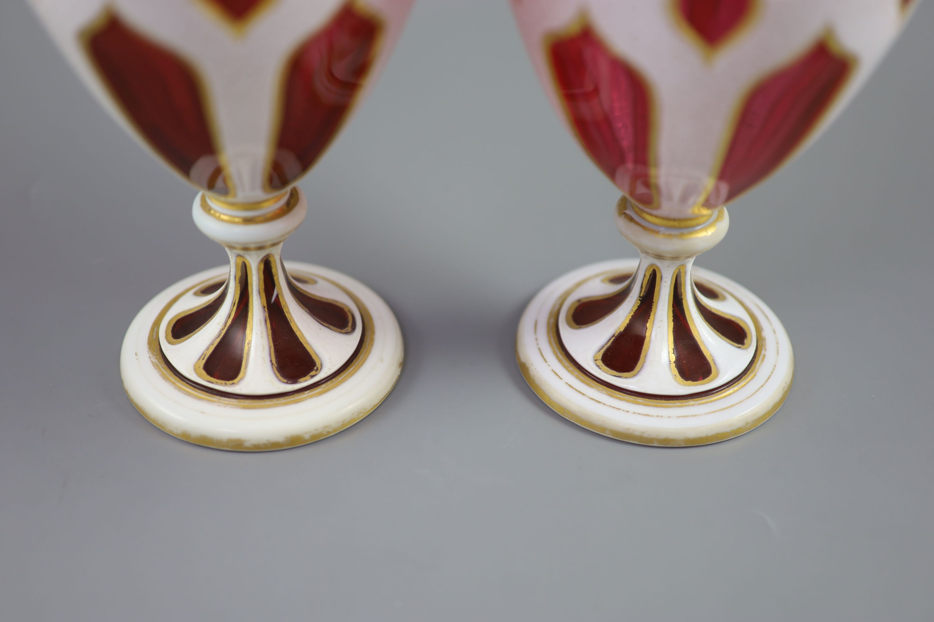 A pair of Bohemian white and ruby overlaid glass vases, 31cm high
